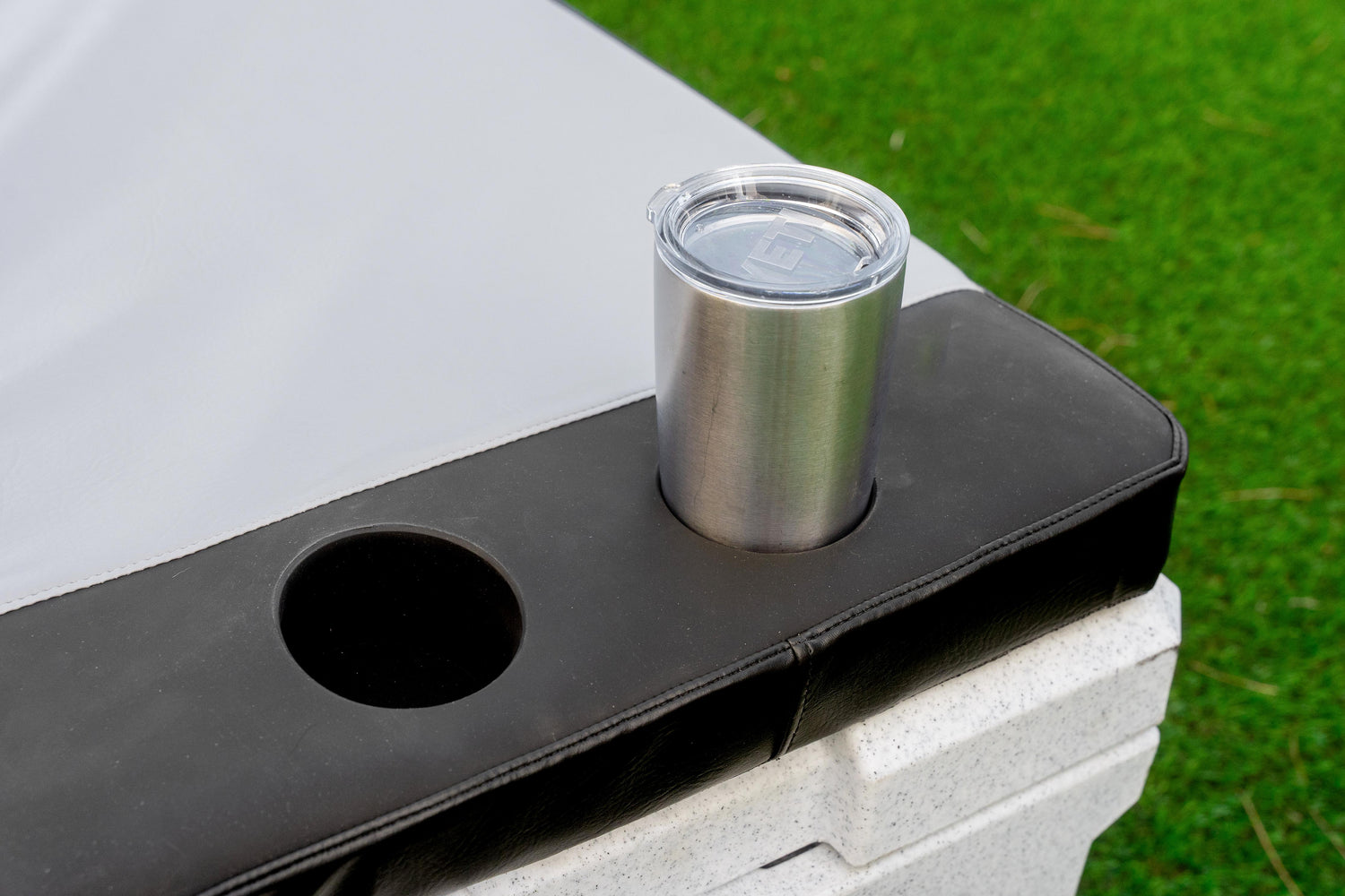 Silicone cup holder integrated into marine cooler seat cushion